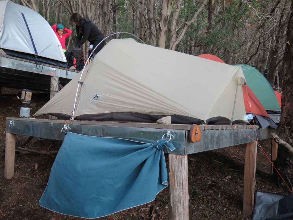 Tent pitched on a wooden platform using hammer and nails